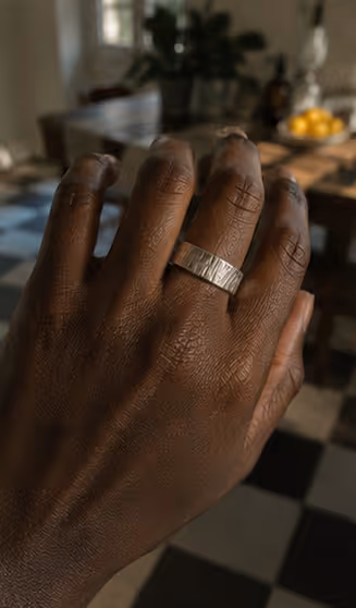 Hand wearing ring in kitchen